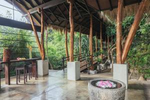 a pavilion with a table and chairs and plants at Uga Jungle Beach in Trincomalee