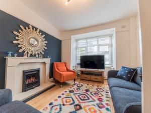 a living room with a fireplace and a tv at Pass the Keys Cosy Cottage Nestled in the Center of Ulverston in Ulverston