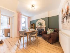 a living room with a table and a chair at Pass the Keys Cosy Cottage Nestled in the Center of Ulverston in Ulverston