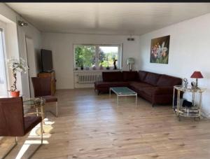 a living room with a couch and a table at Ferienwohnung mit Seeblick in Hagnau