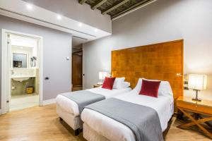 a hotel room with two beds with red pillows at Hotel Delle Nazioni in Rome