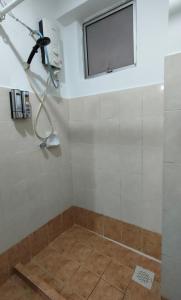 a shower in a bathroom with a window at Cozzzzy Two Next to Axiata Arena, Bukit Jalil in Kuala Lumpur