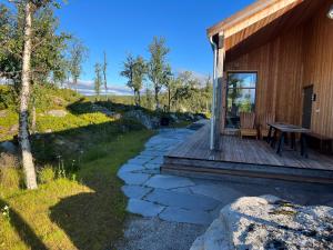 Cabaña de madera con mesa en la cubierta en Skarvhytta - moderne hytte med flott beliggenhet, en Seim