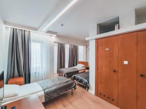 a hotel room with two beds and a cabinet at Motel Almy in Zenica