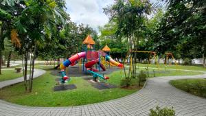 a playground with a slide in a park at Cozzzzy Two Next to Axiata Arena, Bukit Jalil in Kuala Lumpur