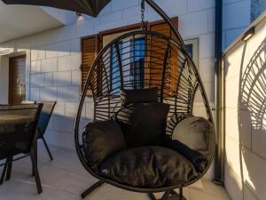 a hanging chair with a pillow in a room at Villa Antica in Ražanj