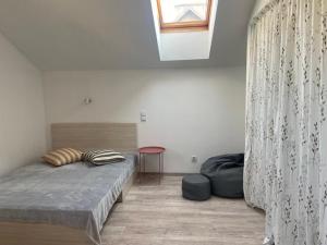 a bedroom with a bed and a window at Apartament Chopina in Suwałki