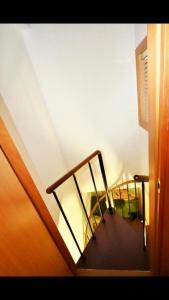a stairway with a wooden rail and a stair case at Il Minotauro B&B a 5 minuti da Popoli in Vittorito