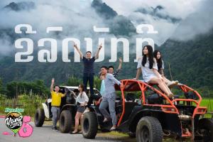 a group of people sitting on the back of a jeep at Vangvieng Rock Backpacker Hostel in Vang Vieng