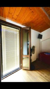 a room with a sliding glass door and a window at Il Minotauro B&B a 5 minuti da Popoli in Vittorito