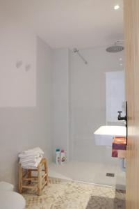 a white bathroom with a sink and a toilet at Hostal Marblau Ibiza in Ibiza Town