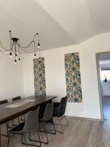 a dining room with a table and chairs at Apartament Chopina in Suwałki