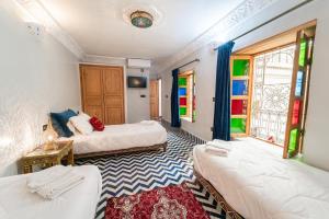 Postel nebo postele na pokoji v ubytování Riad Taj Salma
