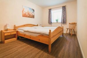 a bedroom with a bed and a table and a window at Hof Böhmetal in Schneverdingen