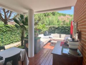 a patio with a couch and a table on a patio at Un petit coin de Paradis in Toulouse