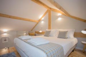 a bedroom with a large white bed in a attic at Liiiving in Porto - Santa Catarina Twin Apartments in Porto
