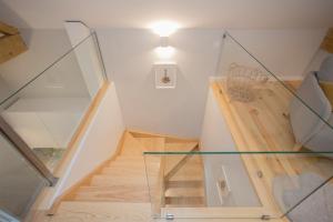 a room with a staircase with a glass case at Liiiving in Porto - Santa Catarina Twin Apartments in Porto