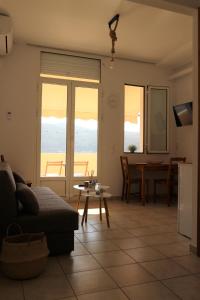 a living room with a view of the ocean at Plateia sea view loft in Samos