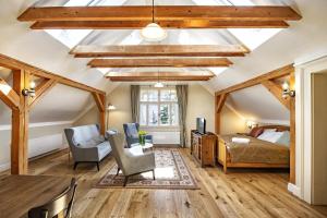 a bedroom with a vaulted ceiling with wooden beams at Vila Lavina in Vysoke Tatry - Novy Smokovec