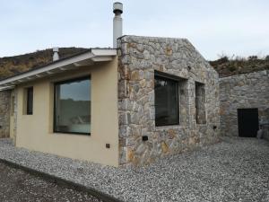 a stone house with a stone wall at Loft en Rincon de la Cumbre in La Cumbre