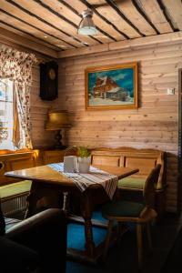 a wooden room with a wooden table and chairs at Hanka Relax & Spa in Zieleniec
