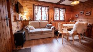 AyerにあるChalet Bella Vouarda. Cosy traditional alpine stayのソファとテーブルと椅子のあるリビングルーム
