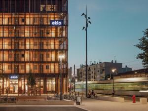 a train passing by a building with a train at Eklo Toulouse in Toulouse