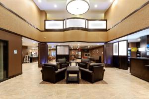 a lobby with a waiting room with chairs and a table at Holiday Inn Express Hotel & Suites Cheyenne, an IHG Hotel in Cheyenne