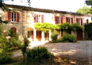 a large brick house with red doors and windows at Résidence Bel Air in Crest