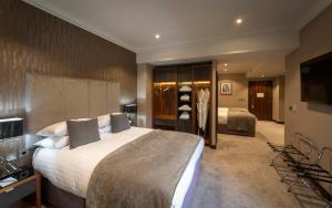 a hotel room with a large bed and a television at Ten Square Hotel in Belfast