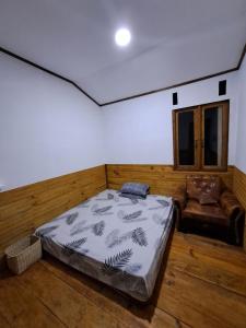 een kamer met een bed en een bank erin bij Mama Tia Family Homestay in Rantepao