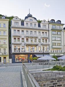 a large white building with tables in front of it at EA Hotel Elefant in Karlovy Vary