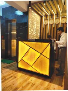 a man standing in front of a large glass door at Royal Galaxy in Kolkata