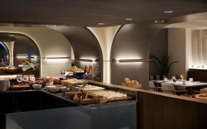 a buffet line in a restaurant with food on display at Teight Hotel in Thessaloniki