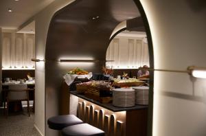 a buffet in a restaurant with a table with food at Teight Hotel in Thessaloniki
