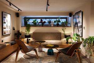 a living room with a couch and some plants at Teight Hotel in Thessaloniki