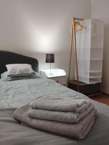 a bedroom with a bed with three towels on it at Havel Apartment in Opole