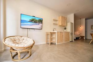 a living room with a tv hanging on a wall at Donna Suite in Arrecife