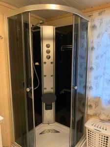 a shower with a glass enclosure in a bathroom at Lofotparadis - nydelig hytte på unikt sted in Valberg