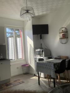 een keuken met een tafel en een magnetron bij T2 proche du lac in Aix-les-Bains