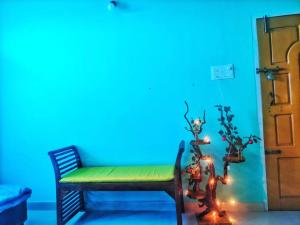 a room with a blue wall and a bench with lights at Aashna Castle in Dispur