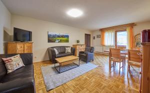 a living room with a couch and a table at Appartement Mountain & Fun in Saalbach Hinterglemm