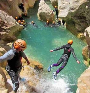 a group of people jumping into a river at studio cabine Font Romeu in Font Romeu Odeillo Via