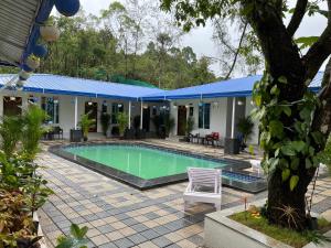 a house with a swimming pool in a yard at Buddha Tree Home Stay in Sringeri