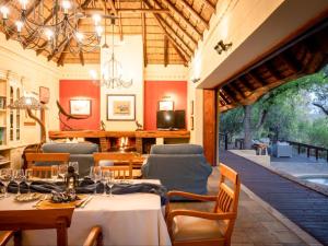 a restaurant with tables and chairs and a patio at Shimungwe Lodge in Hoedspruit