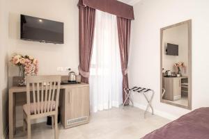 a bedroom with a bed and a desk and a mirror at DANY GUEST HOUSE in Rome +33 photos