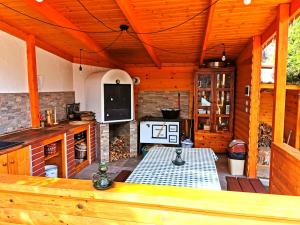 a large kitchen with a table in a cabin at Bükki Villa in Bükkszék