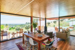 a living room with a wooden table and chairs at Casa Chão de Ourém, O charme em Montargil. in Montargil