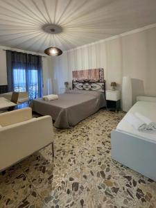 a bedroom with two beds and a living room with a couch at Casa di Nenna in Vallo della Lucania