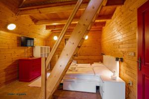a room with a staircase in a wooden cabin at Chalets & Apartments - Base Camp Medvědín in Špindlerův Mlýn